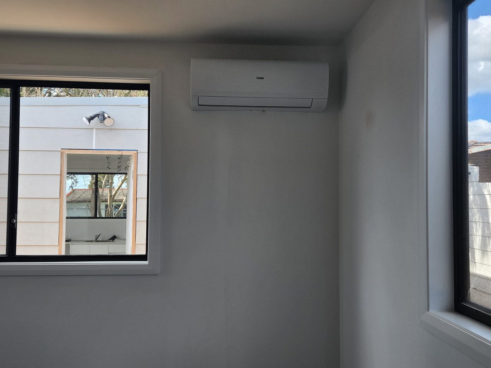 Newly installed split system on an interior wall, ready to run